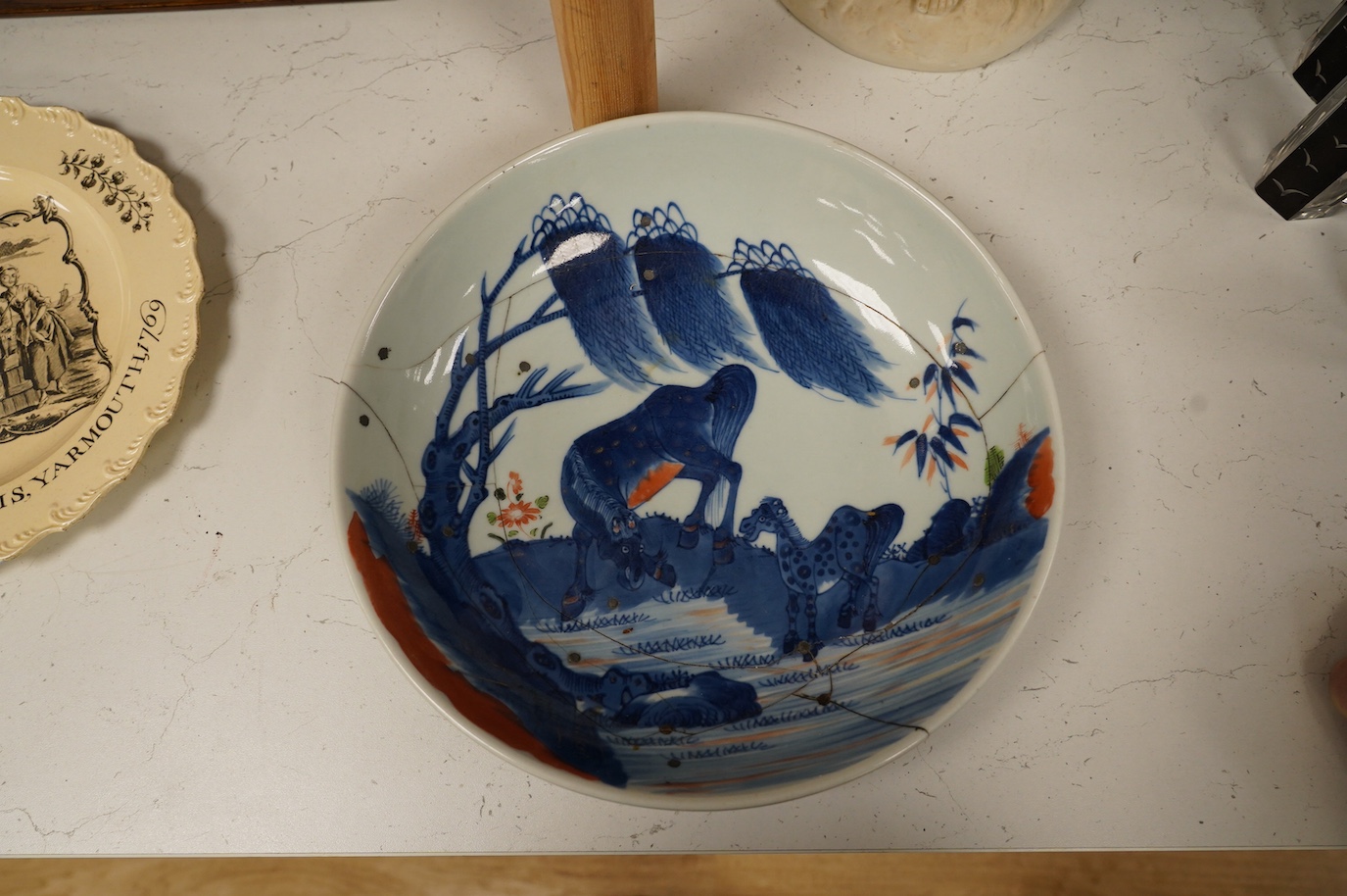 A Chinese underglaze blue and red and green enamelled 'horses' dish, Yongzheng period, 28.5cm. Condition - poor